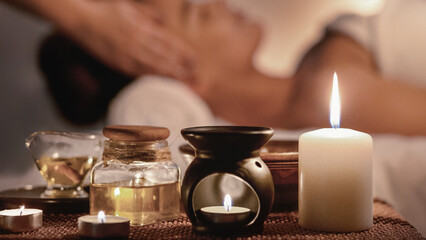 Fototapeta na wymiar Perfect evening. Woman enjoying face massage and aroma spa