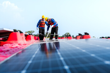 Male workers repair Floating solar panels on water lake. Engineers construct on site Floating solar...