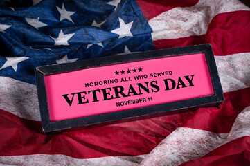 Veterans Day sign on USA flag in background November 11 holiday