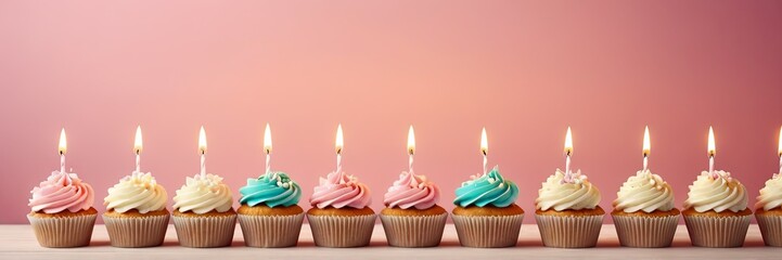 Colorful cupcakes with lit candles are displayed against a pink background, indicating an indoor celebration event marking of joy and celebrating. banner with free space