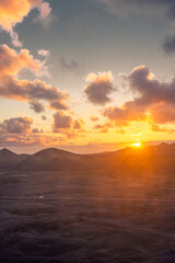 Amazing sunset over El Cuervo Volcano, in Lanzarote, Canary Islands,  Spain - obrazy, fototapety, plakaty