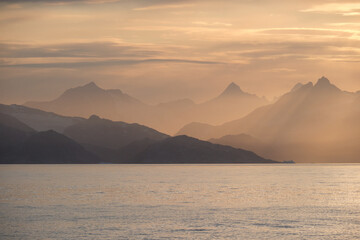 East Greenland coastal sunset - shades of yellow, orange and apricot