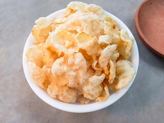 bowl of popcorn. Kerupuk emping, emping or crackers made from melinjo seeds which are flattened, dried in the sun and then fried. Traditional crackers taste bitter and crunchy