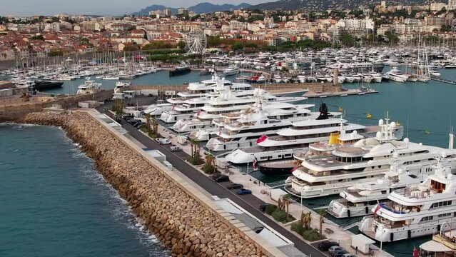 Super Mega Yachts in the French Riviera in the port of Antibes - Aerial sunrise flyover
