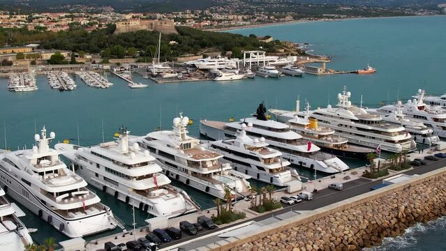 Super Mega Yachts in the French Riviera in the port of Antibes - Aerial sunrise flyover