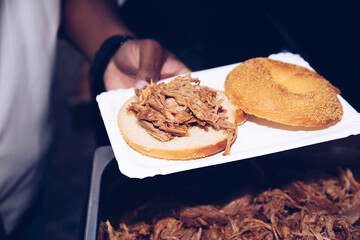 Close-Up of Pulled Pork Sandwich Preparation on Plate