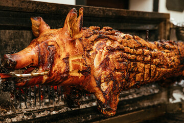 Close-up of a Roasted Whole Pig on a Spit at a Barbecue