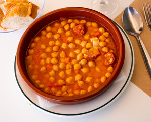 Garbanzos a la riojana, a spanish chickpeas stew with ham in a restaurant