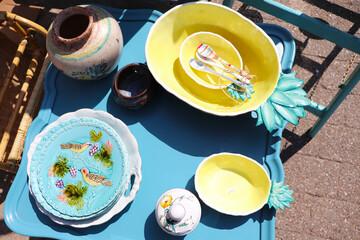 original vintage ceramic dishes on a wooden table at a flea market