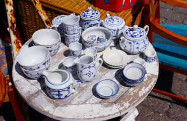 original vintage ceramic dishes on a wooden table at a flea market