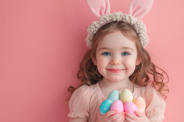 Fototapeta na wymiar Easter celebration: girl with bunny ears, holding colorful eggs on pink background - festive portrait
