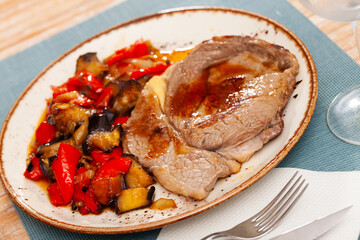 Delicious homemade baked beef steak served with eggplant vegetable saute with bell pepper, onion...