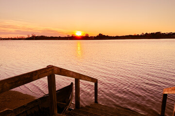 Fototapeta premium Azurreira, Ovar, Portugal. Wide view of the natural scenery of sunset over the water in Ria de Aveiro.