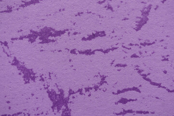 A vibrant purple wall featuring a rough, textured pattern, ideal for backgrounds or graphic elements.