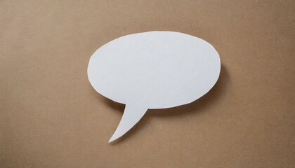 White paper cut out speech bubble shape set on brown paper background