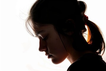 Sad young woman with lowered head profile silhouette on white background