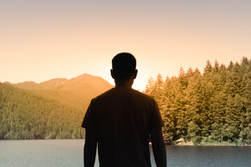 Traveler Young Man Looking Out to Beautiful Golden Sunrise Enjoying View of Nature Mountains,...