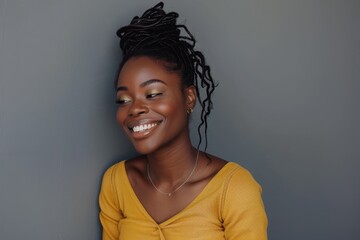 Smiling African woman attractive and happy standing on gray background