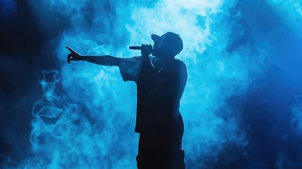 Fotobehang Silhouette of rap singer performing on stage. Bright blue background with hip hop artist performing on concert in night club © buraratn