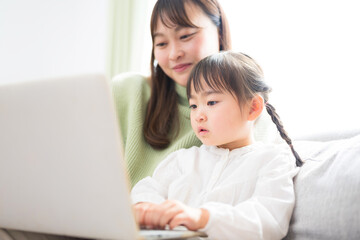 子どもと一緒にパソコンを見て楽しむ親子　何かを見つけたり楽しむオンライン学習など　クローズアップ