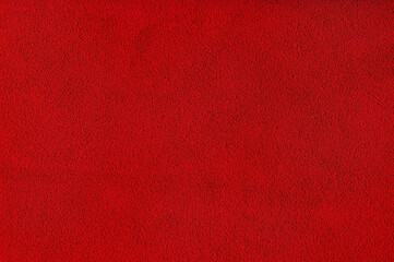 Red velvet background studio photo. Macro photo of natural red-dyed suede.