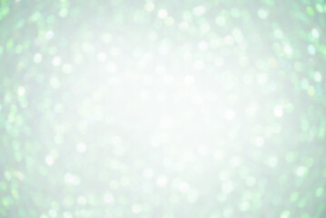 Obraz na płótnie Canvas Defocus lights white on light green color. Abstract background with blurred sparkles.