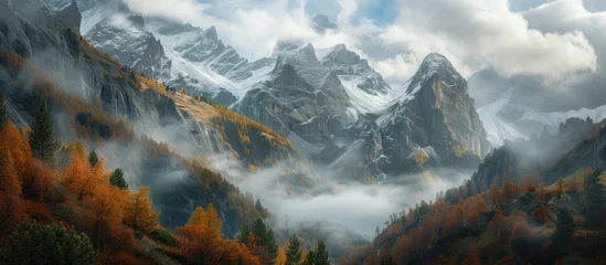 Papier Peint photo Alpes This painting depicts a majestic mountain range with clouds hovering above and trees dotting the landscape. The artist has captured the beauty of nature in this stunning portrayal.