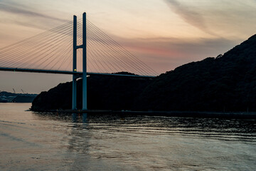 Obraz premium The Megami Ohashi Bridge in Nagasaki, Japan at sunset viewed from the water