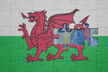 puzzle with the national flag of wales and euro banknote. finance concept