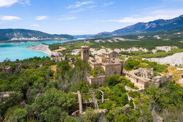 Fototapeta na wymiar Aerial view of ruins of abandoned village of Tiermas by Yesa reservoir in Spain, Summer 2023
