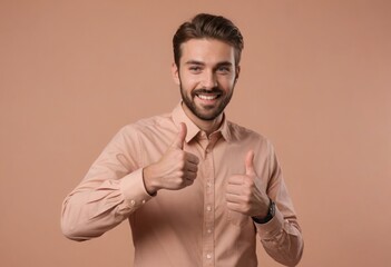A happy man in a peach shirt with two thumbs up. His facial expression is cheerful and approving.