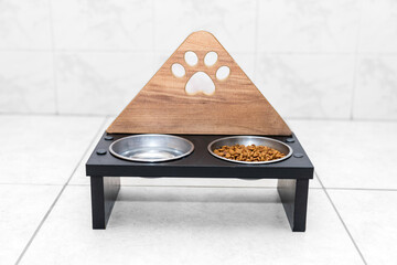 wooden pet food container. A cat dish and water dish filled with food and water. A metal cat bowl...