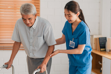 Obraz premium Asian physiotherapist nursing home to support old senior man patient therapy by walker, caregiver nurse help recovery health care with elderly retirement man person at home, health insurance concept
