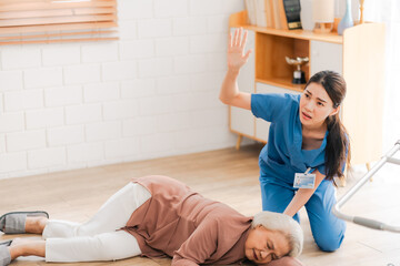 senior patient falling on the ground floor at home, Asian caregiver helping elderly older female from accident after doing physical therapy then rescued by attractive therapist nurse, health insurance - 746869354