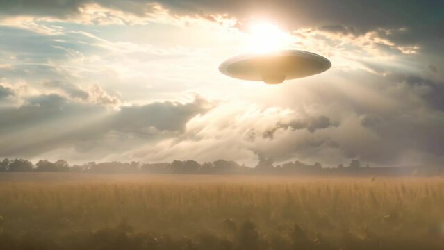 Animation of an UFO hovers above a golden wheat field, with dramatic clouds and sunbeams illuminating the mysterious scene
