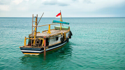 A traditional passenger ship is on the coast of Gili Island, Indonesia