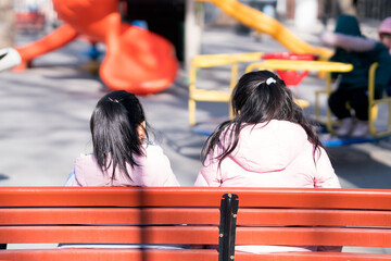 Two girls are sitting in chairs behind them
