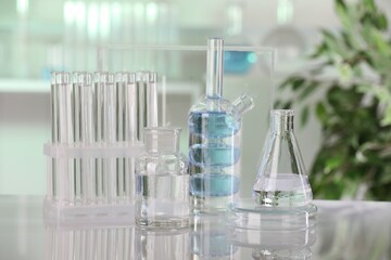 Laboratory analysis. Different glassware with liquid on white table indoors