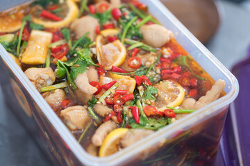 Spicy chicken feet marinated in a lunch box