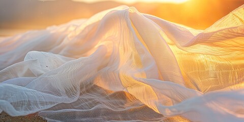 A light fabric dances gracefully in the wind on the beach at sunset. White linen fabric in sinuous movement that reflects the serenity and ephemeral beauty of the moment.