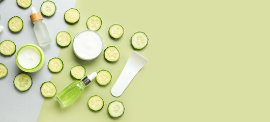 Natural cosmetics, spatula and cucumber slices on color background with space for text