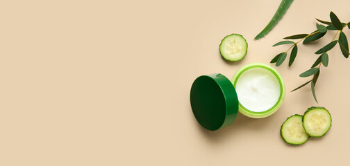 Jar of natural cream, cucumber slices and eucalyptus on light background with space for text