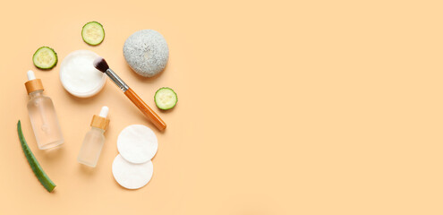 Natural cosmetics, cotton pads, cucumber slices and aloe leaf on beige background with space for...