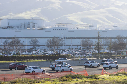 Fremont, CA, USA - Feb 21, 2024: The Tesla Fremont Factory, one of the largest manufacturing sites in California operated by Tesla, Inc., viewed from the other side of the interstate highway I-880.