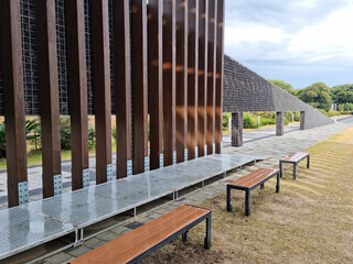 An outdoor park with wooden pillars and benches.