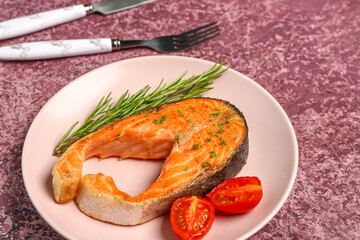 Plate of tasty salmon steak on purple background
