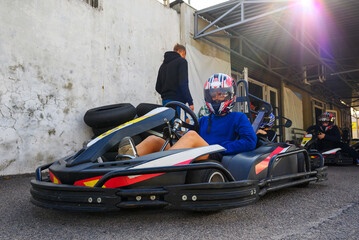 racer in a helmet in front of the pits