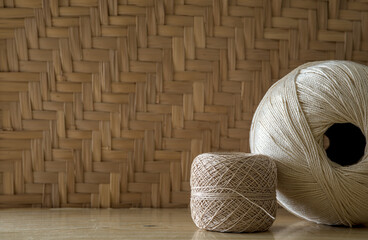 Fototapeta na wymiar balls of thread on wood with natural background