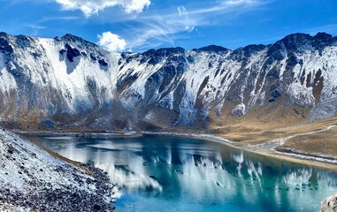 View of lake bellow snow capped mountain