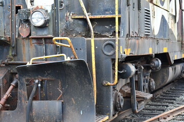 Older diesel locomotive rusting on tracks.